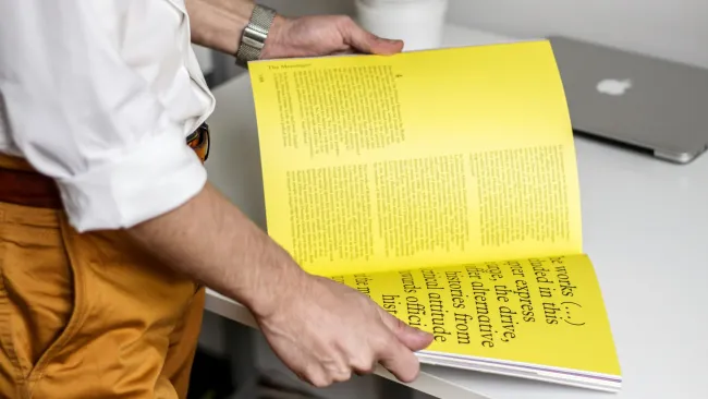 a man holding a yellow box